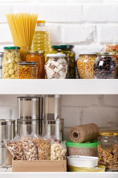 A close-up of organized shelves in a pantry, stocked with various non-perishable items like canned goods, pasta, and spices. The shelves are neatly arranged, showing a variety of brands and products, emphasizing organization and preparation through strategic shopping hauls.