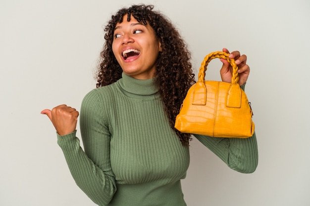 A person happily holding up a recently purchased pre-owned designer handbag, smiling confidently, illustrating the satisfaction and enjoyment of finding a great deal on a luxury item in the secondhand market.