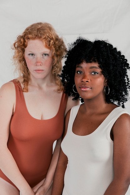 A collage featuring diverse models of different sizes and ethnicities wearing clothing from brands known for size inclusivity, such as Universal Standard and Aerie. The models are smiling and confident.